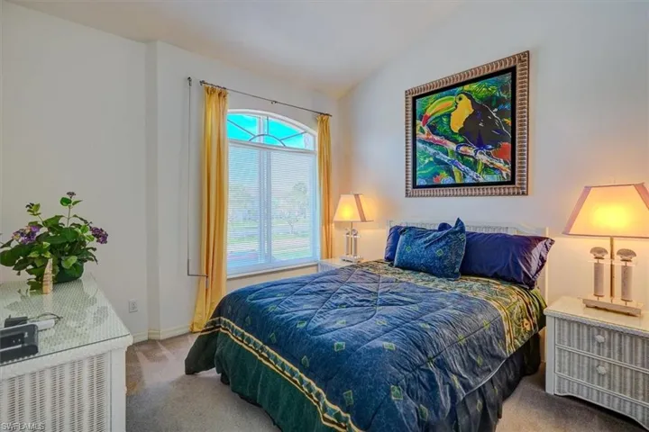 Bedroom with carpet flooring and vaulted ceiling