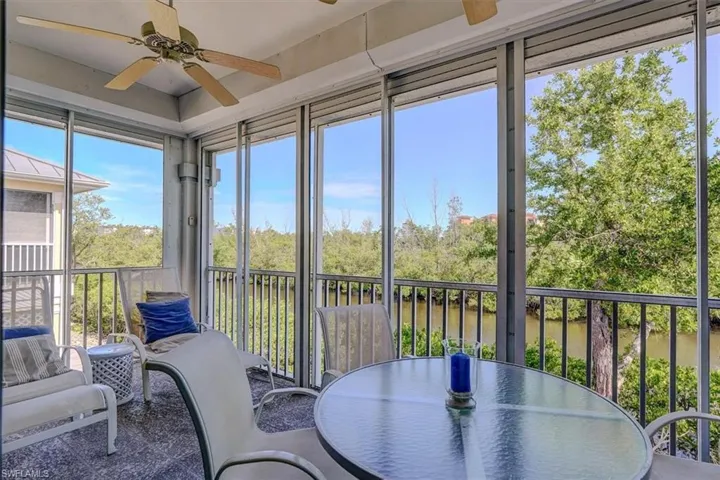 Sunroom with a ceiling fan and outdoor dining space