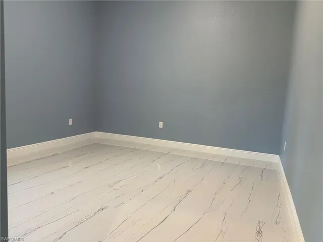 Unfurnished room featuring baseboards