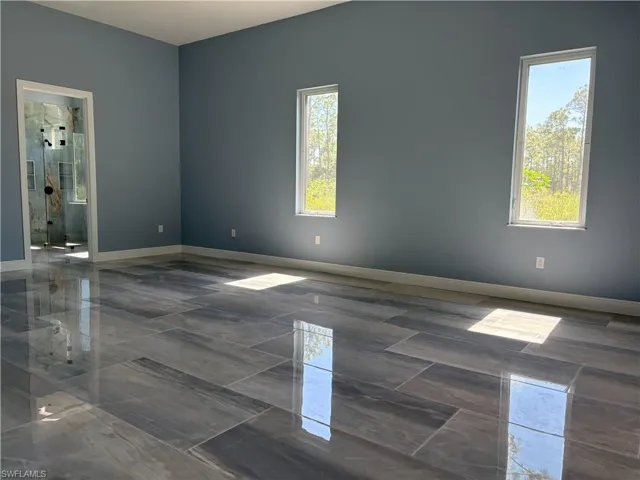 Spare room featuring baseboards