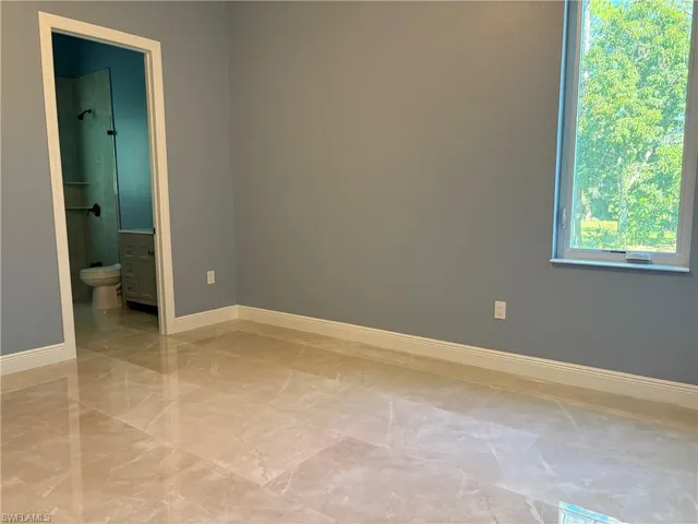 Unfurnished room with baseboards