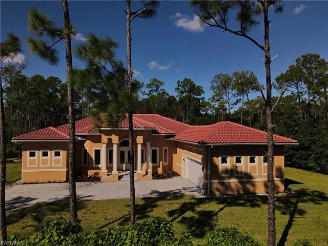 Mediterranean / spanish-style house featuring a tiled roof, stucco siding, and a front yard