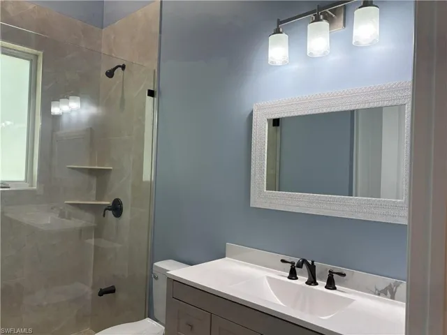Bathroom featuring a stall shower and vanity