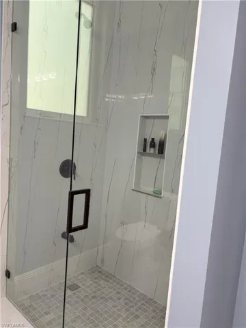 Bathroom with a marble finish shower