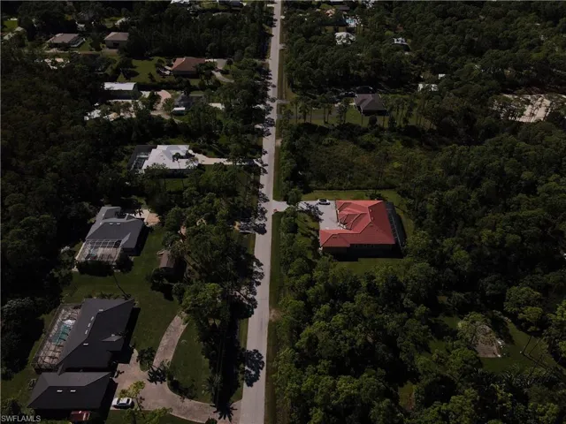 Aerial view of property's location featuring a forest