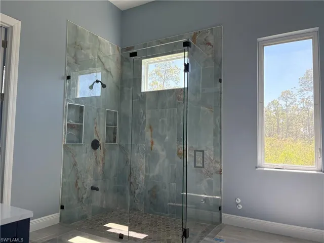 Bathroom with a shower stall and vanity