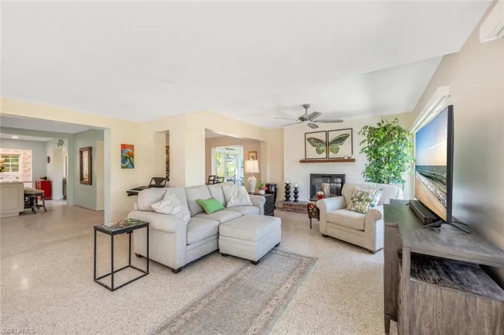 Living room with a fireplace and ceiling fan