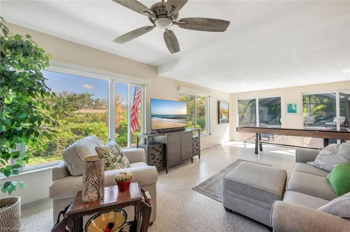 Living room featuring a wealth of natural light and ceiling fan