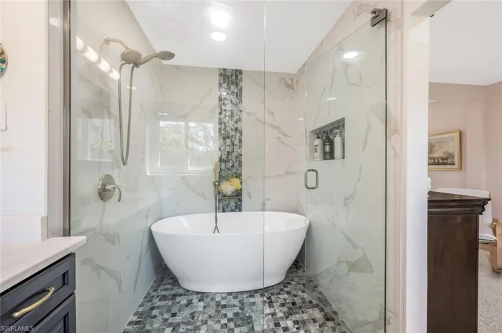 Bathroom with vanity, plus walk in shower, and tile walls