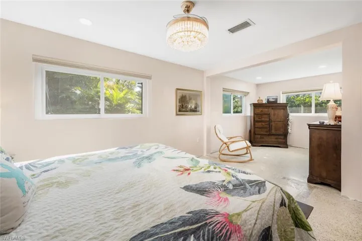 Bedroom with an inviting chandelier