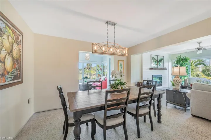 Dining room featuring a healthy amount of sunlight and ceiling fan with notable chandelier