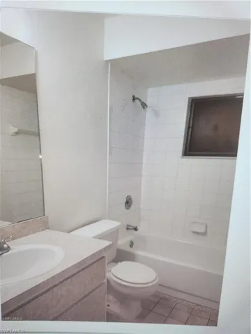 Full bath featuring vanity, shower / bathtub combination, and light tile patterned floors