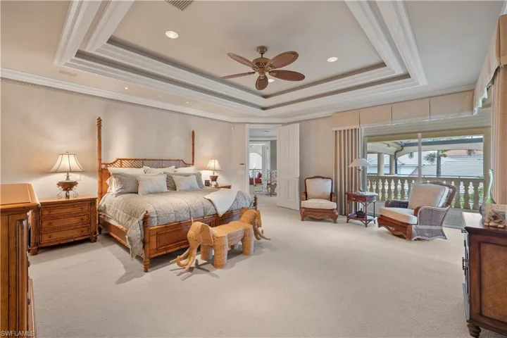 Carpeted bedroom with crown molding, a ceiling fan, and recessed lighting