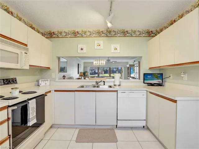 Full view of the kitchen with window into the living area