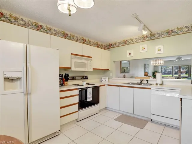 Kitchen with lots of cabinet space for storage and tile flooring