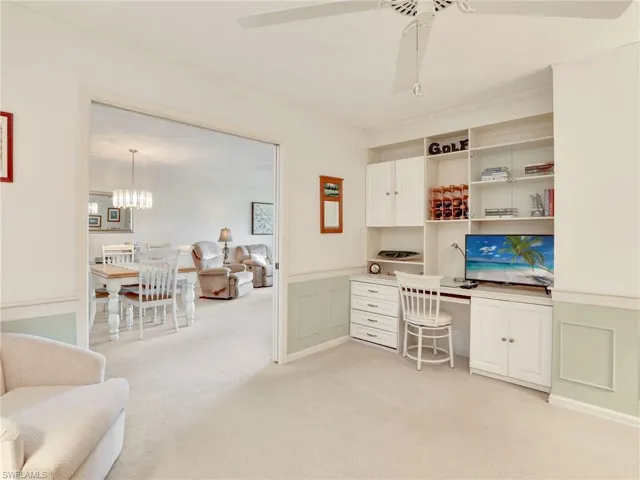 Den with pocket door and built-in desk with dental molding