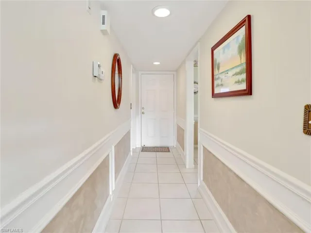 Entry foyer with doorways to one side - the guest bedroom & bathroom, laundry room  and to the other side to the kitchen