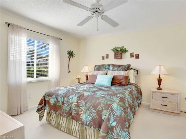 Primary bedroom with window to gorgeous view of lake & golf course behind