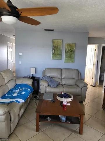 Tiled living area with a textured ceiling