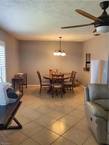Dining room featuring a textured ceiling, light tile patterned floors,