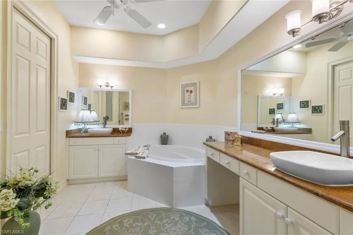 Private Bathroom featuring double vanities and separate tub and shower