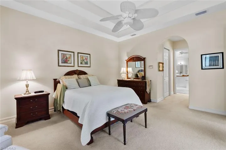 Bedroom with carpet, ceiling fan, private bathroom