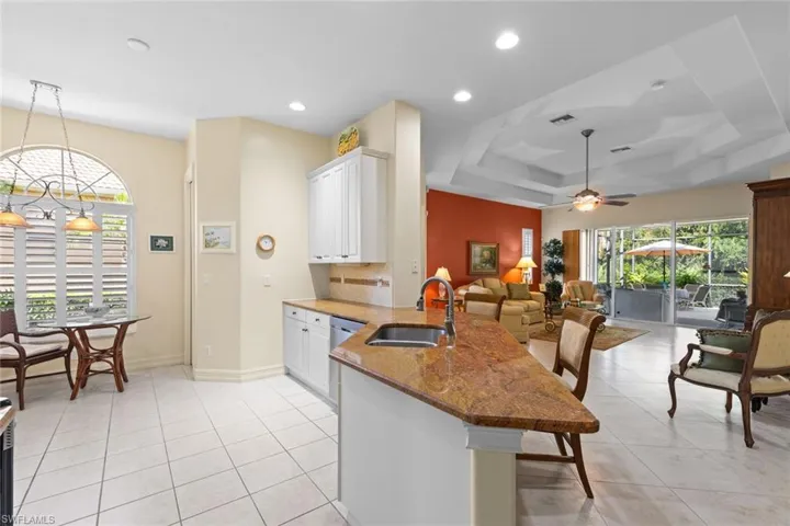 Kitchen featuring white cabinetry and granit counters