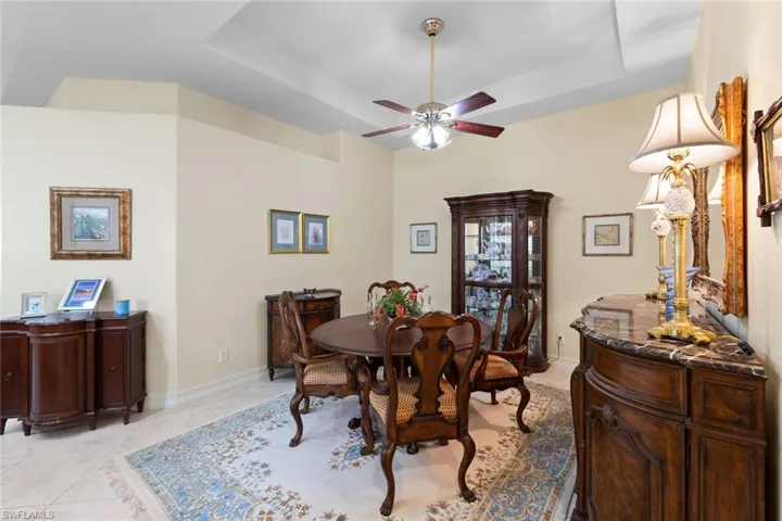 Formal dining room features a tray ceiling