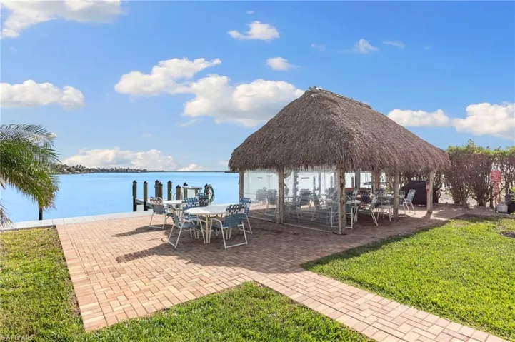 Sit right by the water as boats pass by under the Chickee