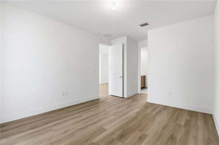 Spare room with light wood-style flooring and baseboards