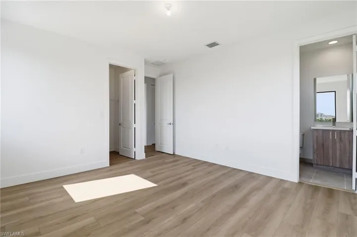 Bathroom featuring double vanity and light tile patterned floors