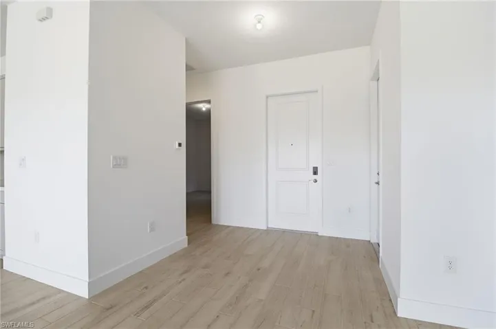 Unfurnished bedroom with light wood-style flooring and baseboards