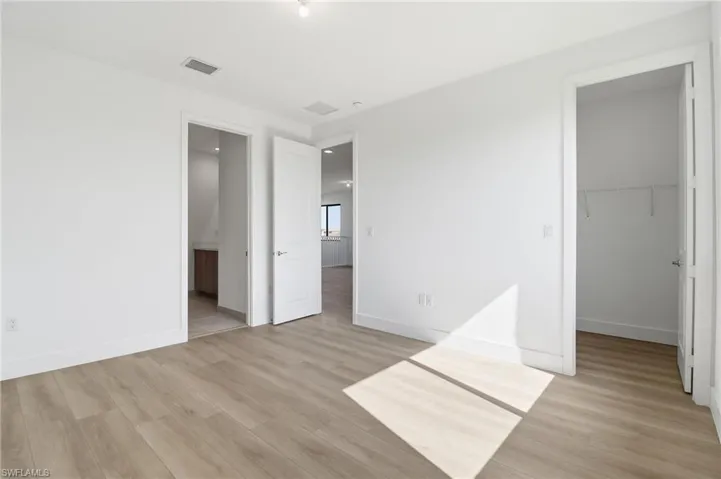Spare room with light wood-type flooring and plenty of natural light