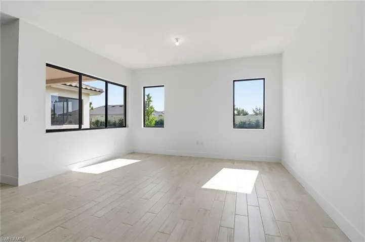 Empty room with light wood-style flooring and baseboards