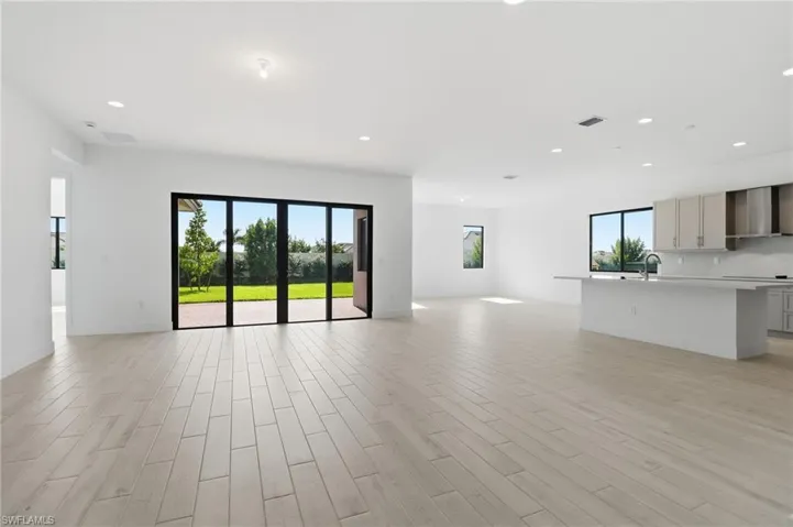 Unfurnished living room featuring wood tiled floors and recessed lighting