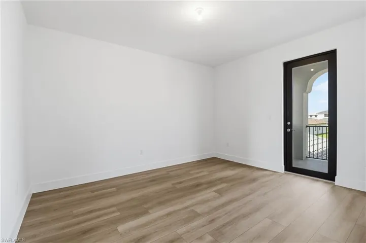 Empty room with light wood-style flooring and baseboards