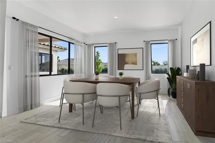 Dining space with light wood-style flooring and plenty of natural light