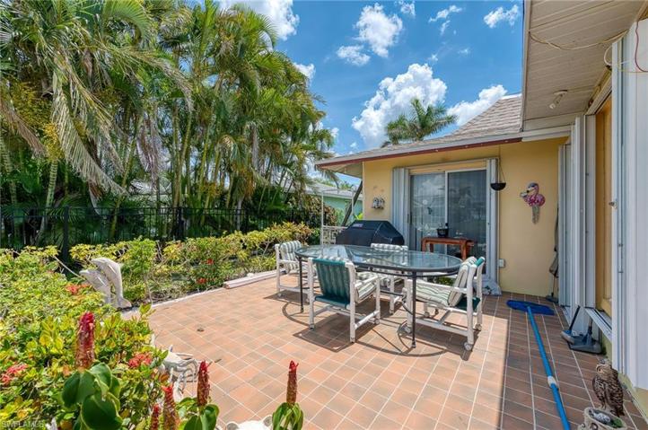 This is a 2nd Patio / Lanai area with sliders from the Kitchen & the 2nd Bedroom. It opens to the pool area.