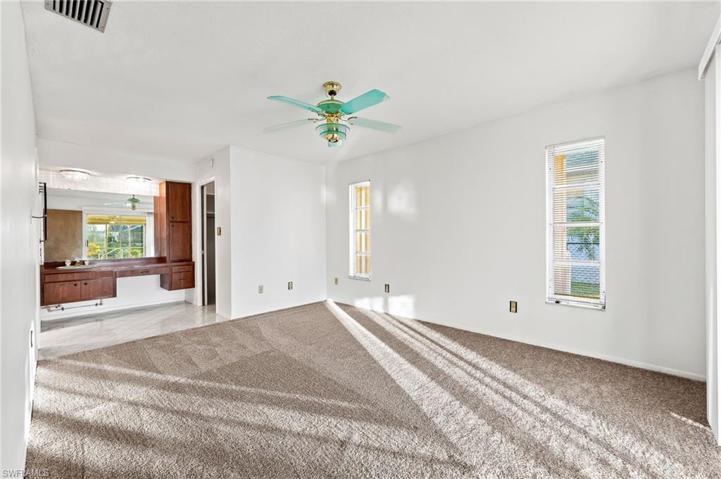 New carpet in Master Bedroom. Open to makeup area with sink. Walk-in closet to the right.