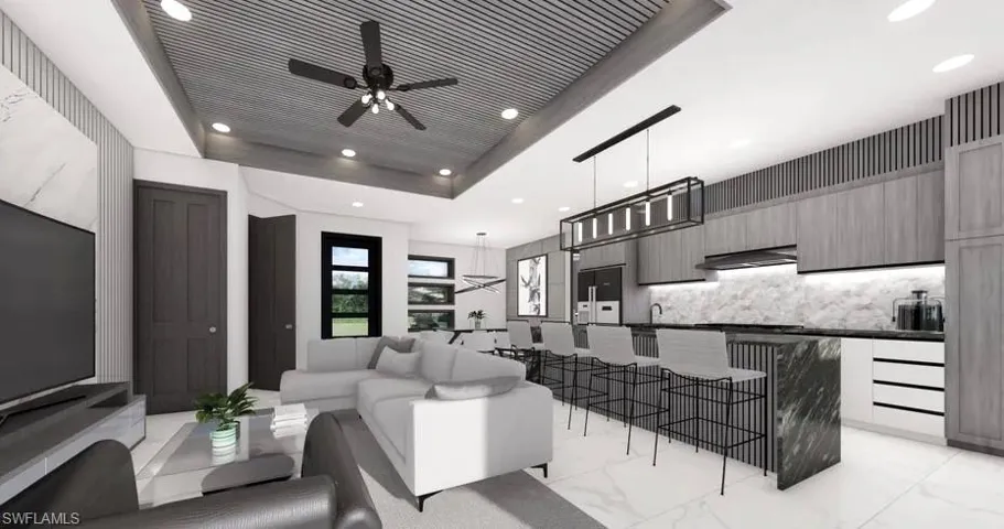 Open-concept living area featuring a kitchen island with a waterfall countertop, integrated bar seating, and a linear pendant light fixture