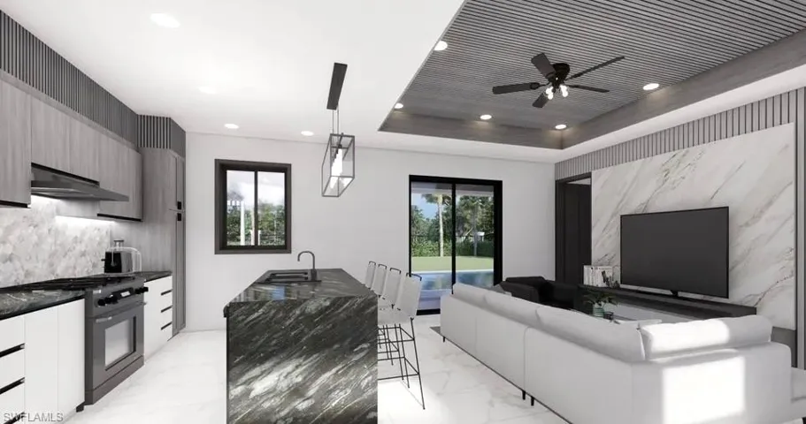 Contemporary kitchen and living area featuring a stone island with seating, a full-size range, recessed lighting, and a detailed ceiling design with a ceiling fan
