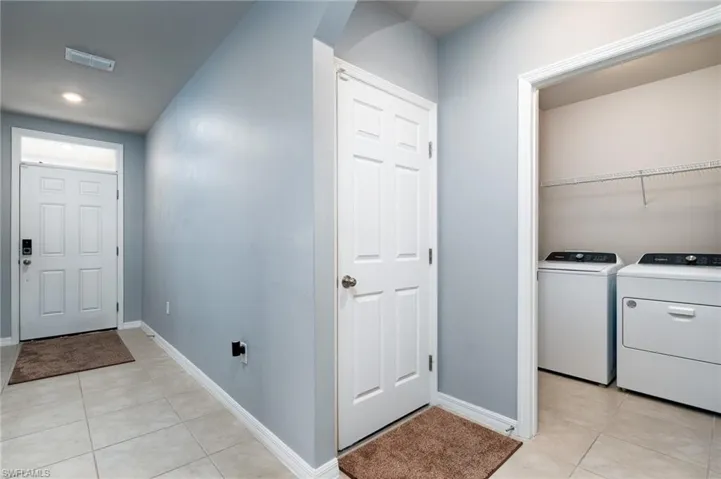 Entryway leads to 2 guest rooms on one side, and Laundry on the other