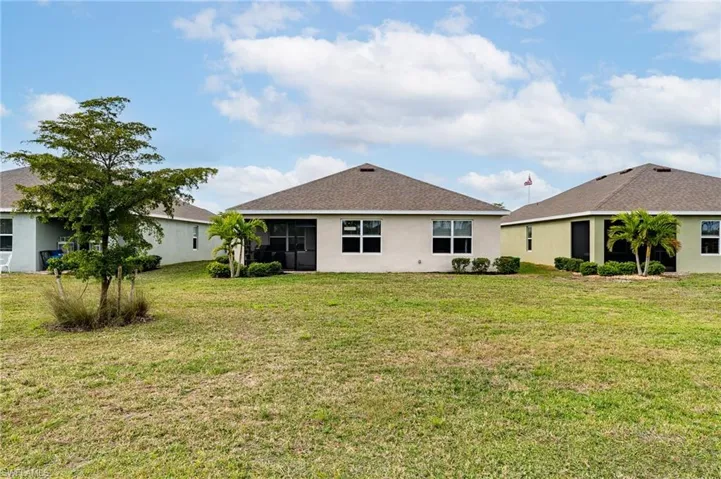 Rear view of house with mature landscaping