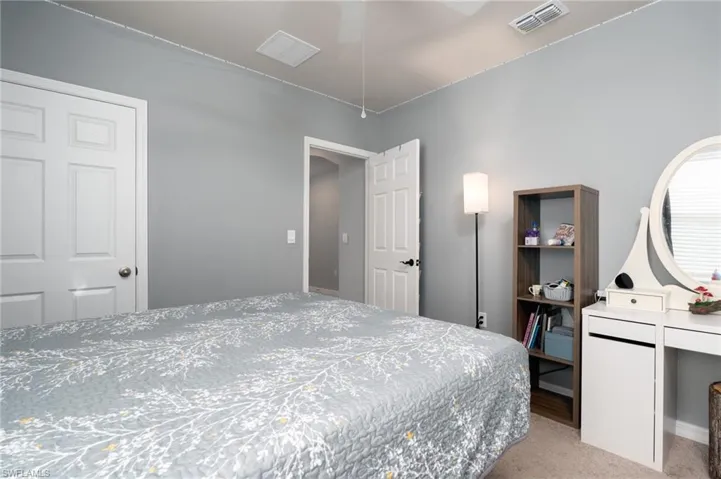 Bedroom featuring light carpet and ceiling fan