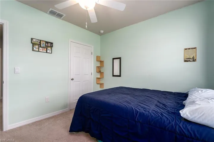 Bedroom with carpet floors and a ceiling fan
