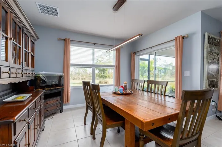 Dining area featuring tile floors, baseboards, and Sliders to Lanai