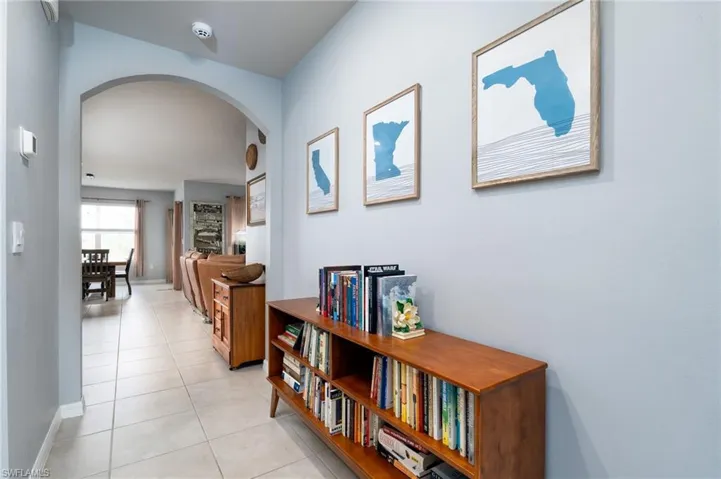 Spacious foyer featuring arched doorways and light tile flooring