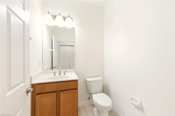 Half bath featuring vanity and toilet