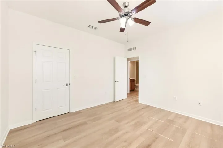 Unfurnished bedroom with light wood-type flooring and ceiling fan