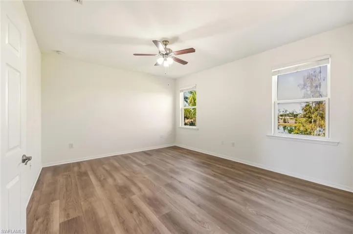 Spare room featuring light wood-type flooring and a ceiling fan